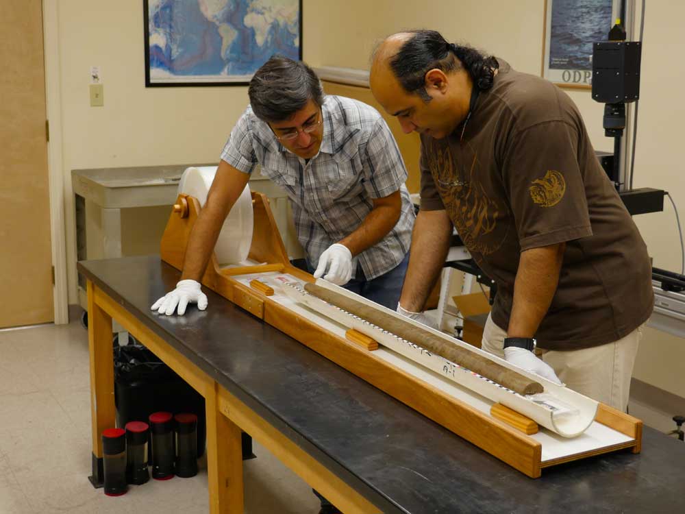 Ali Pourmand (left) and Ph.D. candidate Arash Sharifi inspect the physical properties of a sediment core collected from NW Iran.