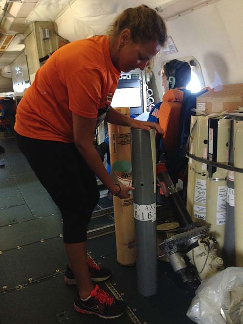 Rosenstiel Ph.D. student Johna Rudzin prepares to drop one of the 55 aircraft ocean instruments into the sea to study hurricane intensity in the Caribbean.