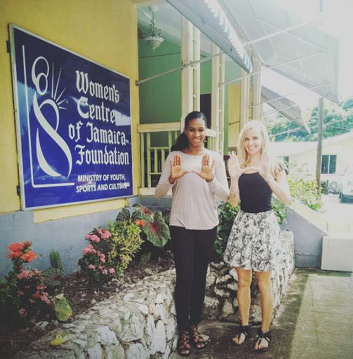 Soroya McFarlane, left, and Kerli Kirch throw up the U in front of the Women’s Centre of Jamaica Foundation in downtown Kingston.