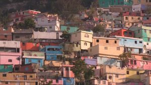 Vibrantly painted homes dot a hillside outside Port-au-Prince, Haiti